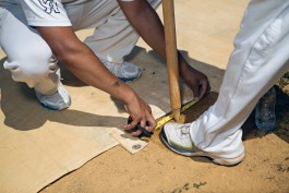 Players setting up wickets for a Washington Cricket League match in Washington, DC. Photo by Noah Willman. `