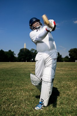 A portrait of a Washington Cricket League player with the Washington Monument in the background. Photo by Washington, DC based photographer Noah Willman. `