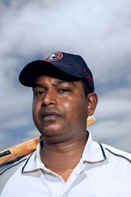 A tight portait of a Washington Cricket League player during a match in Washington, DC. Photo by Noah Willman. `